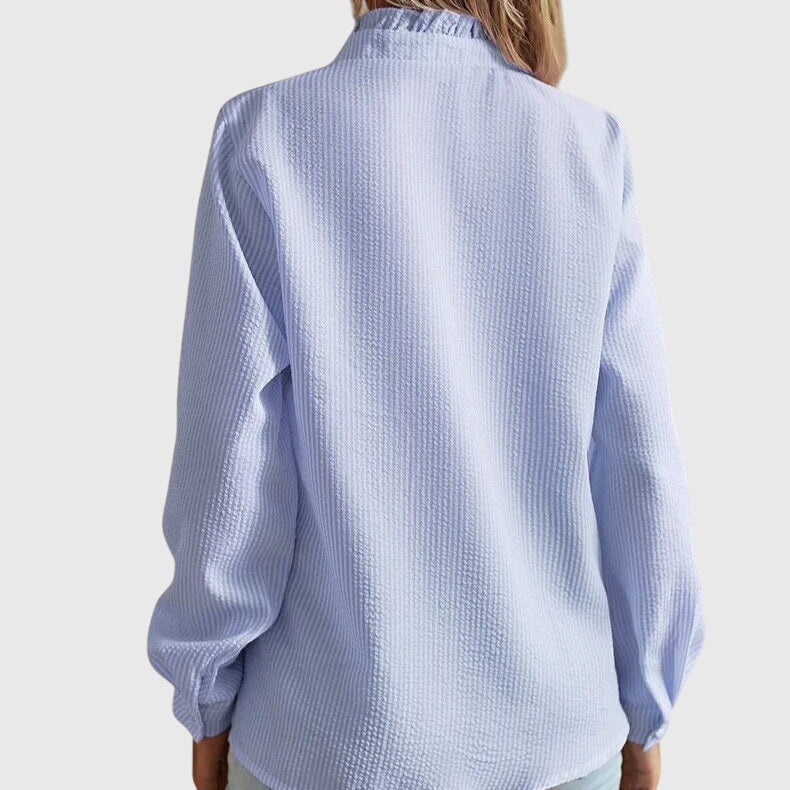 Light blue textured shirt worn by a person on a white background