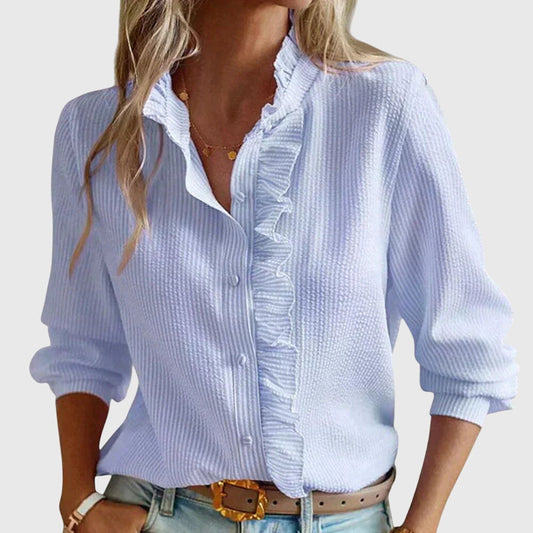 Light blue button-up shirt worn by a person on a plain background