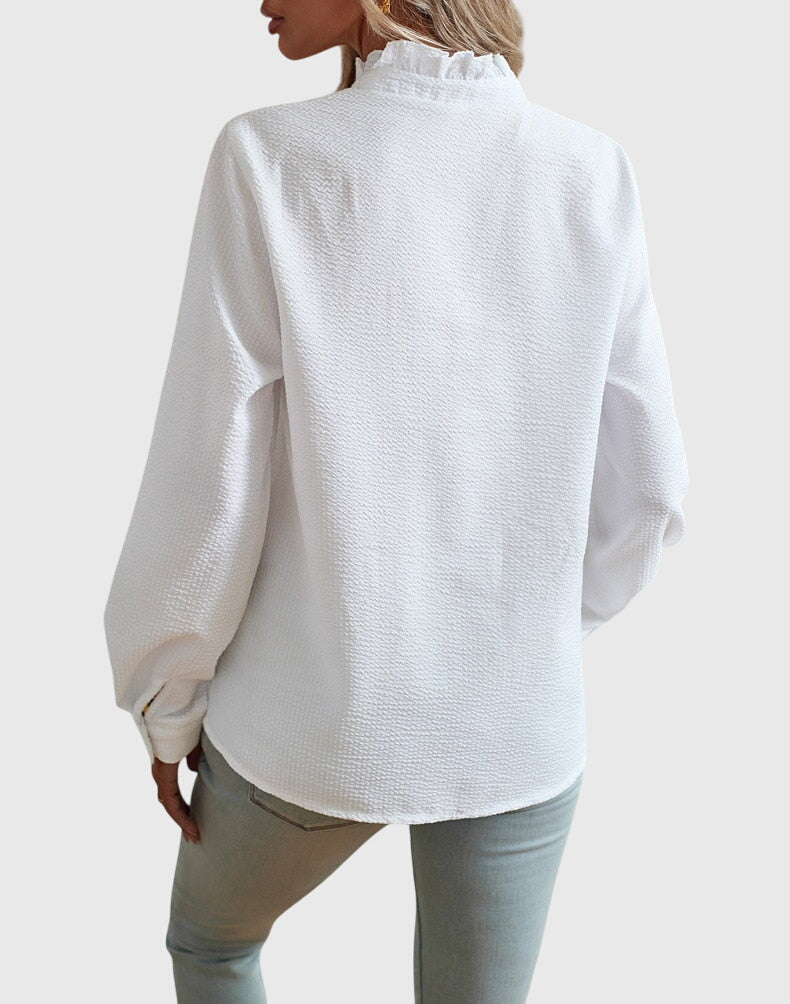 White textured blouse worn by a person on a white background