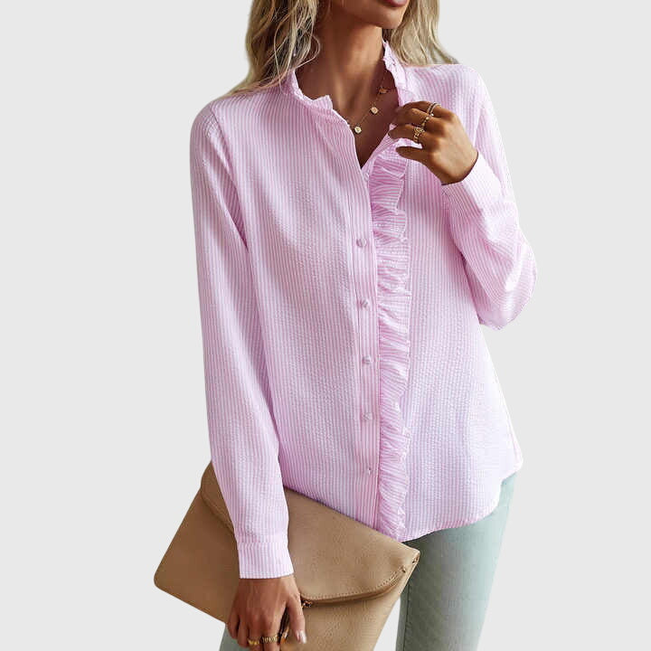 Woman wearing a pink striped shirt with ruffle details on a white background